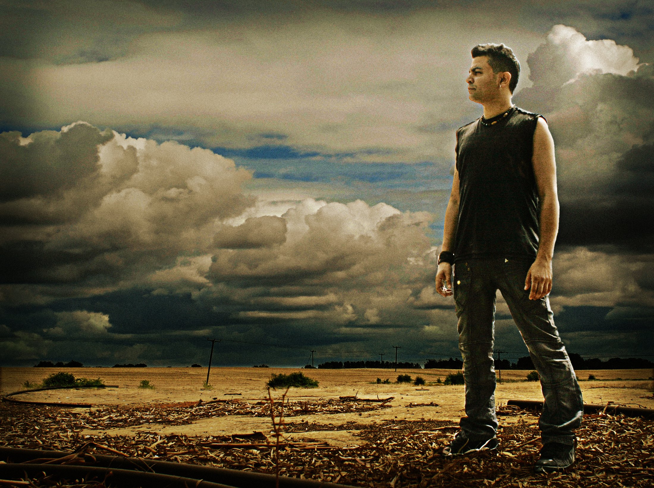 U-RECKEN standing in an open field under a cloudy sky
